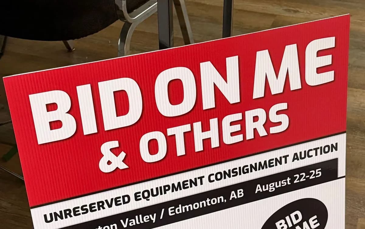 Red and white Team Auctions bid-direction coroplast sign printed in Saskatoon