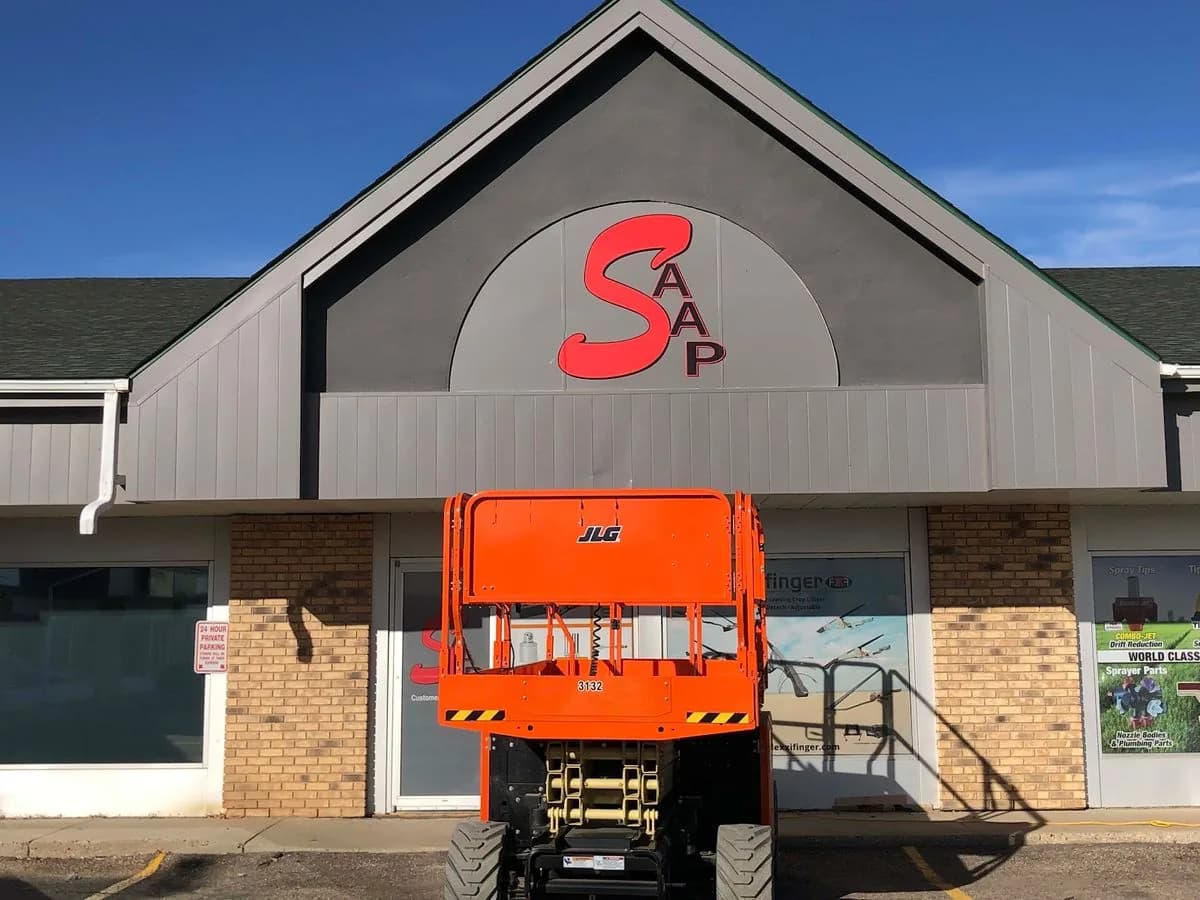 Building sign installation with boom lift by True Color in Saskatchewan